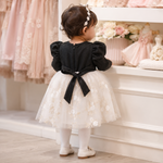 Back view of baby girl wearing black and white net frock suit with back tie and pajama