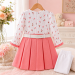 Back view of baby girl wearing coral pink frock suit with white pajama and floral top