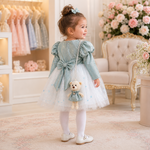 Back view of baby girl wearing dusty blue and white party frock suit with pajama and teddy charm