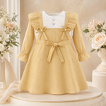 Front view of mustard yellow baby girls frock suit with pajama, bow detail and ruffle sleeves