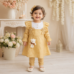 Baby girl wearing mustard yellow frock suit with matching pajama and teddy charm