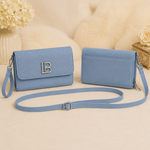 Light blue textured flap crossbody shoulder bag with wristlet and long strap front and back view