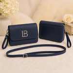 Navy blue textured flap crossbody shoulder bag with wristlet and long strap front and back view